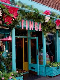 Brightly coloured Finga restaurant entrance with floral decorations.