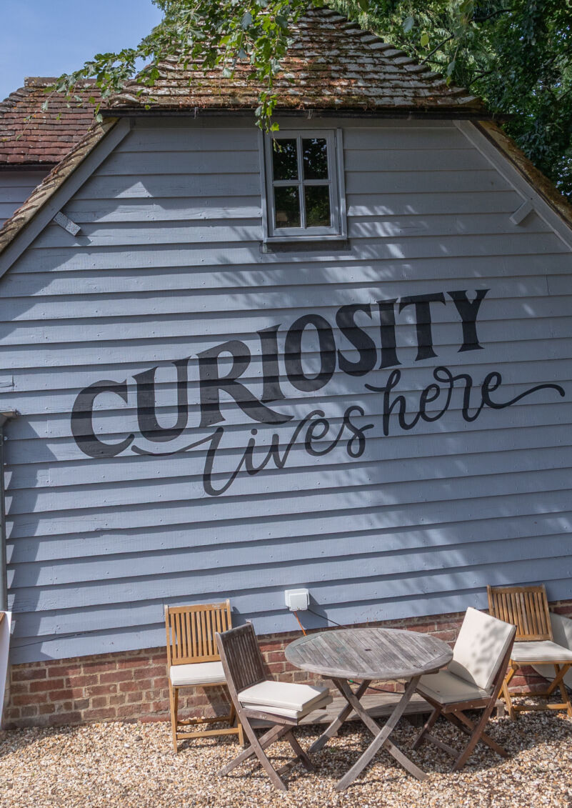 Curiosity Lives Here sign
