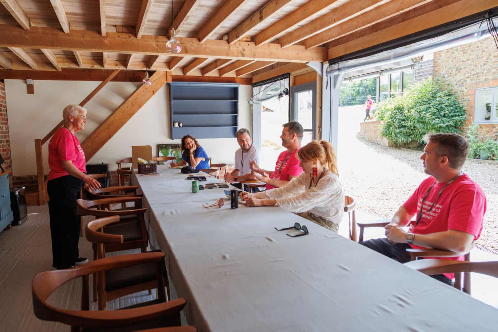Management training and coaching session in a bright, modern meeting room with participants engaged.