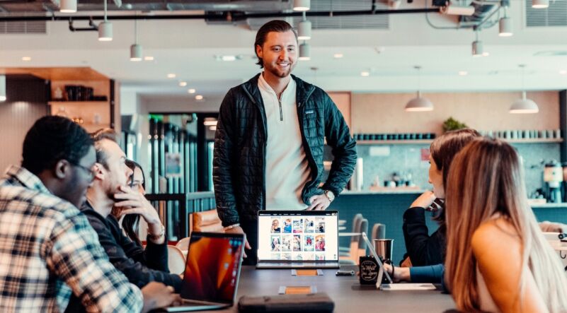 leader coaching team at a desk in the office