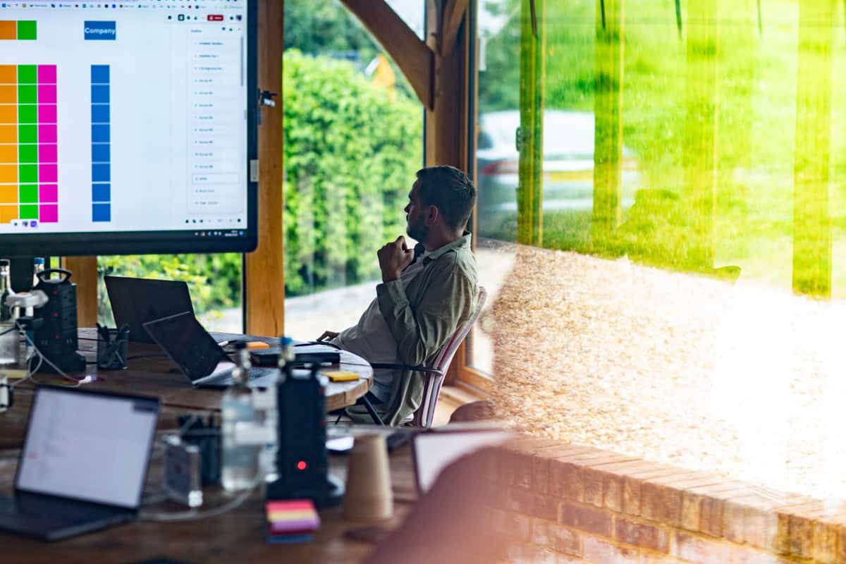 Modern office environment with natural light and outdoor greenery.