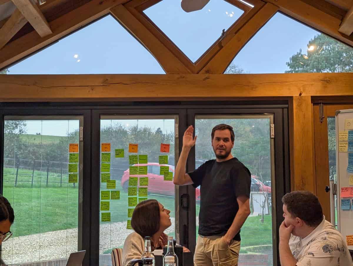 Dominic Monkhouse explaining a founder sales strategy framework at a whiteboard.