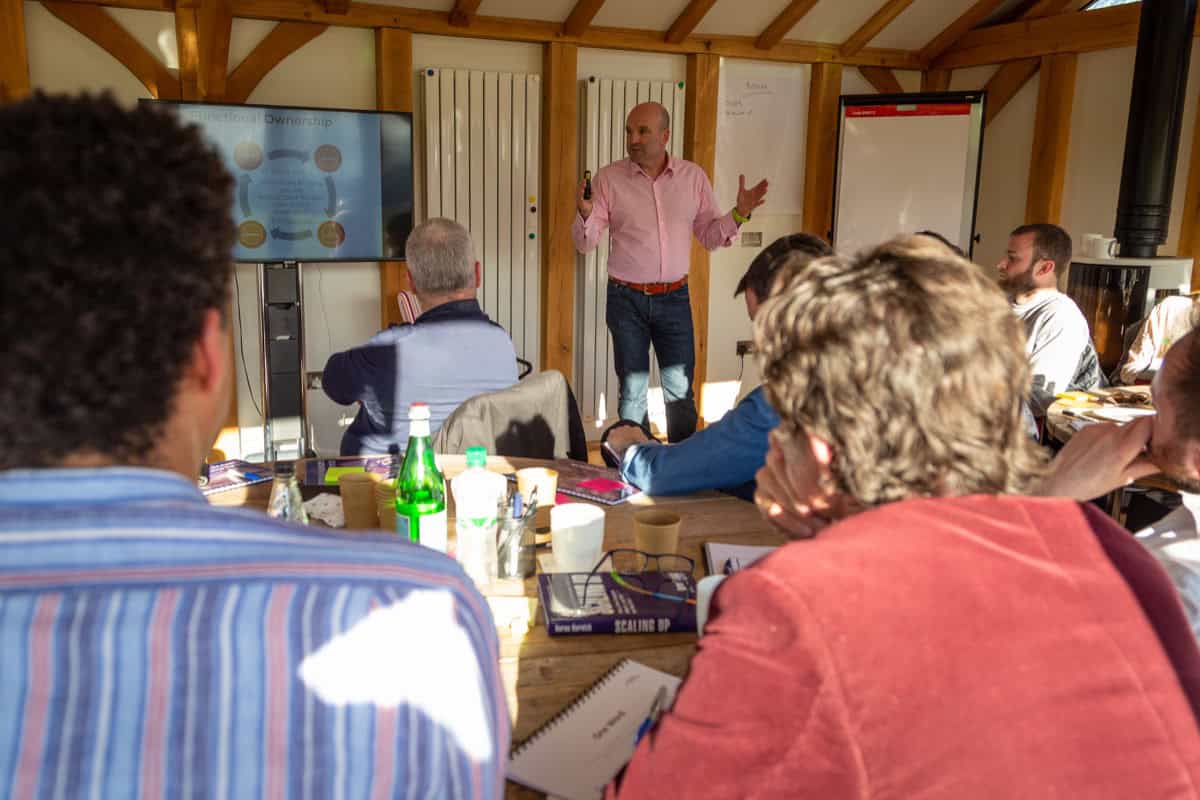 Dominic Monkhouse presenting pricing strategy to a founder coaching group.