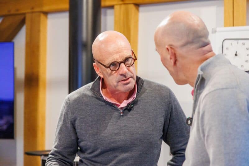 Two founders in a one-to-one coaching conversation on whether the CEO is the right leader past 100 employees.