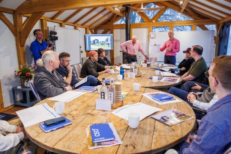 Conference room with team members and presenters at Monkhouse & Company.