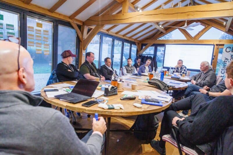 A founder cohort discusses decision rights and professionalising a business around a workshop table.