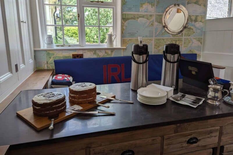 Cake display with coffee flasks at Monkhouse & Company.