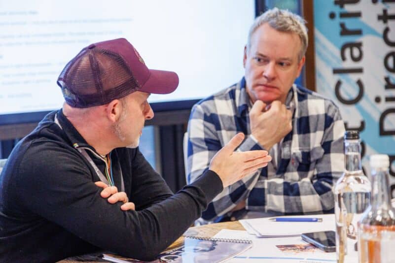 Two founders in a coaching conversation about hiring a first head of sales
