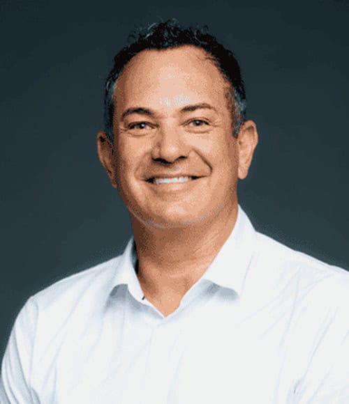Smiling professional man in white shirt for Monkhouse & Company.