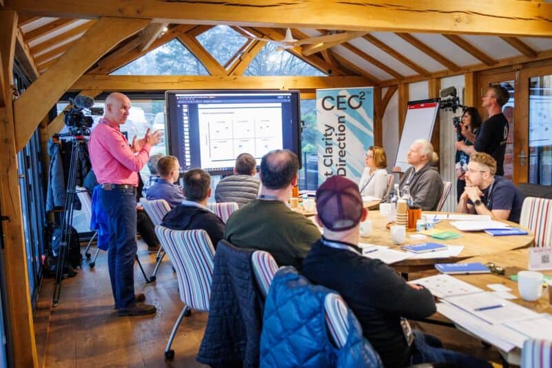 Workshop group reviewing talent recruitment metrics on a large screen