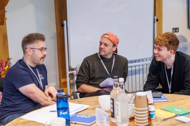 Founders in a cohort discussion weighing up when to hire a salesperson at a Monkhouse and Company workshop