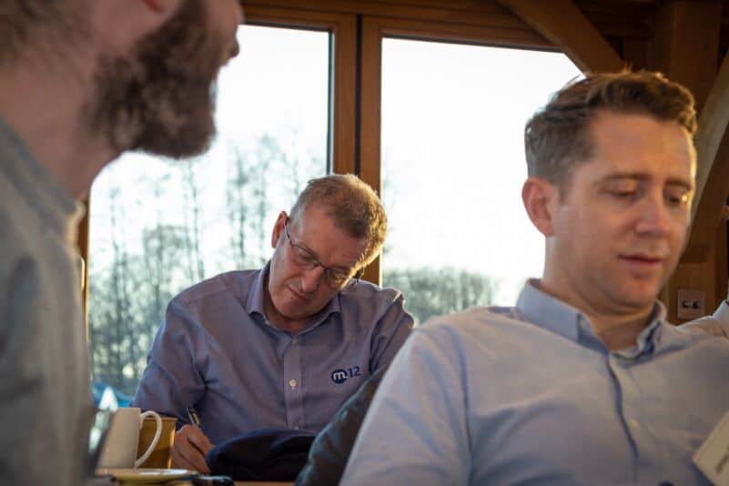 Business professionals in a meeting at Monkhouse & Company office.